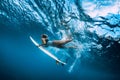 Surfer woman dive underwater. Surfgirl dive under wave