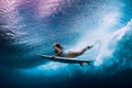 Surfer woman dive underwater. Surfgirl dive under wave