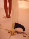 Surfer woman posing with surfboard on the beach at sunset Royalty Free Stock Photo