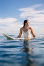 Surfer woman sit on surfboard in ocean Royalty Free Stock Photo