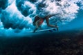 Surfer woman with surf board dive underwater with under big crashing wave Royalty Free Stock Photo