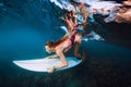 Surfer woman with surf board dive underwater with under big ocean wave Royalty Free Stock Photo