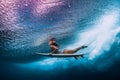 Surfer woman with surfboard dive underwater with under ocean waves Royalty Free Stock Photo