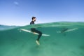 Surfers above and below waterline