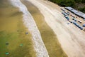 Surfers on the beach and in the ocean at Selong Belanak, Lombok, Indonesia