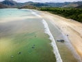 Surfers on the beach and in the ocean at Selong Belanak, Lombok, Indonesia