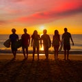 Surfers boys and girls group walking on beach Royalty Free Stock Photo