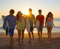 Surfers boys and girls group walking on beach Royalty Free Stock Photo