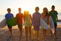 Surfers boys and girls group walking on beach Royalty Free Stock Photo