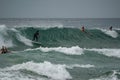 Surfers catching waves and having fun on Manly Beach. Australia. Royalty Free Stock Photo