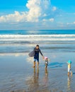 Surfers family children beach. Bali
