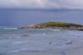 Surfers at Fistral beach bay in Newquay at a cloudy day