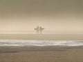 Surfers on Freshwater West beach in Pembrokeshire.