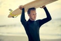 Surfers have saltwater in their veins. a laid-back young surfer watching the waves while holding his surfboard at the Royalty Free Stock Photo