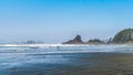 Surfers heading into the Pacific Ocean at Cox Bay Beach at the Pacific Rim National Park Royalty Free Stock Photo