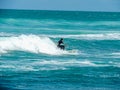 Surfers hitting the waves at Piha Beach Auckland New Zealand