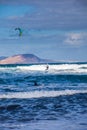 Surfers and kiters in the sea at Famara