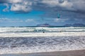 Surfers and kiters in the sea at Famara