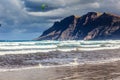 Surfers and kiters in the water on Famara beach