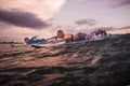 Surfers man and girl are floating on board, gaining speed that Royalty Free Stock Photo