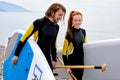 Surfers, man and woman walking with board on beach. water sports. Active Lifestyle Royalty Free Stock Photo