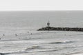 Surfers in the ocean surf at Virginia Beach, VA Royalty Free Stock Photo