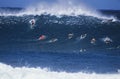 Surfers Paddling Out To Catch Wave