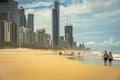 Surfers Paradise, Gold Coast, Australia - People walking along the beach with highrises in the background Royalty Free Stock Photo