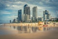 Surfers Paradise, Gold Coast, Australia - People walking along the beach with highrises in the background Royalty Free Stock Photo