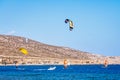 Surfers in Prasonisi Beach in Rhodes island, Greece. Kiteboarder kitesurfer athlete performing kitesurfing kiteboarding tricks.