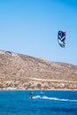 Surfers in Prasonisi Beach in Rhodes island, Greece. Kiteboarder kitesurfer athlete performing kitesurfing kiteboarding tricks.