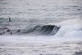 Surfers riding huge waves on the west coast, close to Pillar Point and Mavericks Beach, Half Moon Bay, California Royalty Free Stock Photo