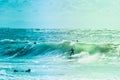 Surfers riding some waves on the sea