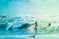 Surfers riding some waves on the sea