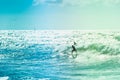 Surfers riding some waves on the sea