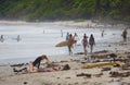 Surfers at the sandy beach of Santa Teresa on a sunny day