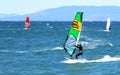 Surfers on a sunny autumn windy day in the waters of the Amur Bay in Vladivostok