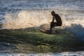 Sunrise Surfer- Riding a wave