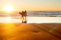 Surfers at sunset, Portugal Royalty Free Stock Photo