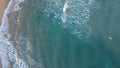 Surfers in the surf waiting for waves in the turquoise ocean off the Victorian Coastline Royalty Free Stock Photo