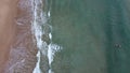 Surfers in the surf waiting for waves in the turquoise ocean off the Victorian Coastline Royalty Free Stock Photo