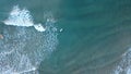 Surfers in the surf waiting for waves in the turquoise ocean off the Victorian Coastline Royalty Free Stock Photo