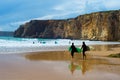 Surfers surfboards beach Portugal cliff