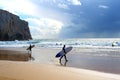 Surfers surfboards beach rain Portugal