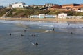 Surfers surfing on Bournemouth beach Dorset England UK near to Poole