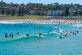 Surfers taking waves on Bondi beach water in Sydney Australia