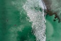 Surfers in tropical ocean waiting wave. Aerial view made with drone Royalty Free Stock Photo