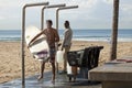 Surfers under the shower, Durban beach