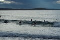 Surfers under a stormy sky