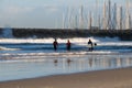 Surfers wait for waves.